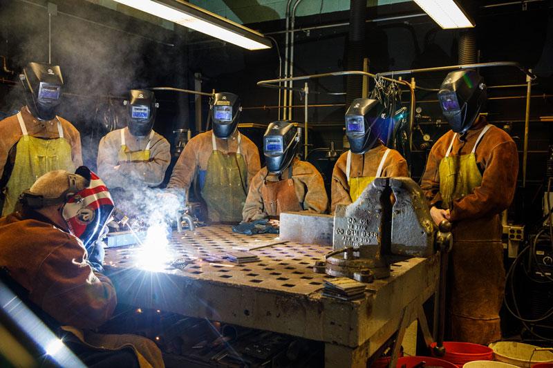 cadets in the welding lab with an instructor welding